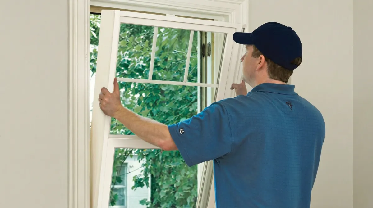 Professional contractors performing a residential window insulation and replacement service in Boston, MA